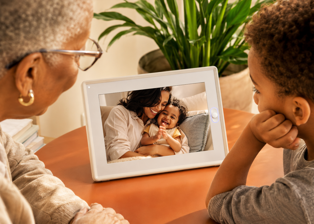 The AmivoFrame conversational AI smart photo frame displaying a happy family portrait on a wooden table