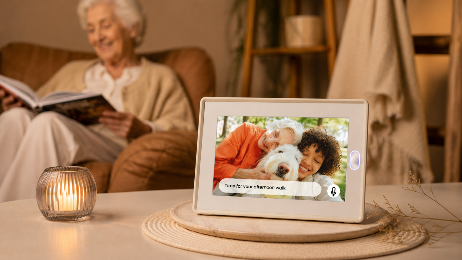 The AmivoFrame conversational AI smart photo frame displaying a happy family portrait on a wooden table in a beautifully styled, sunlit modern living room with a green sofa.
