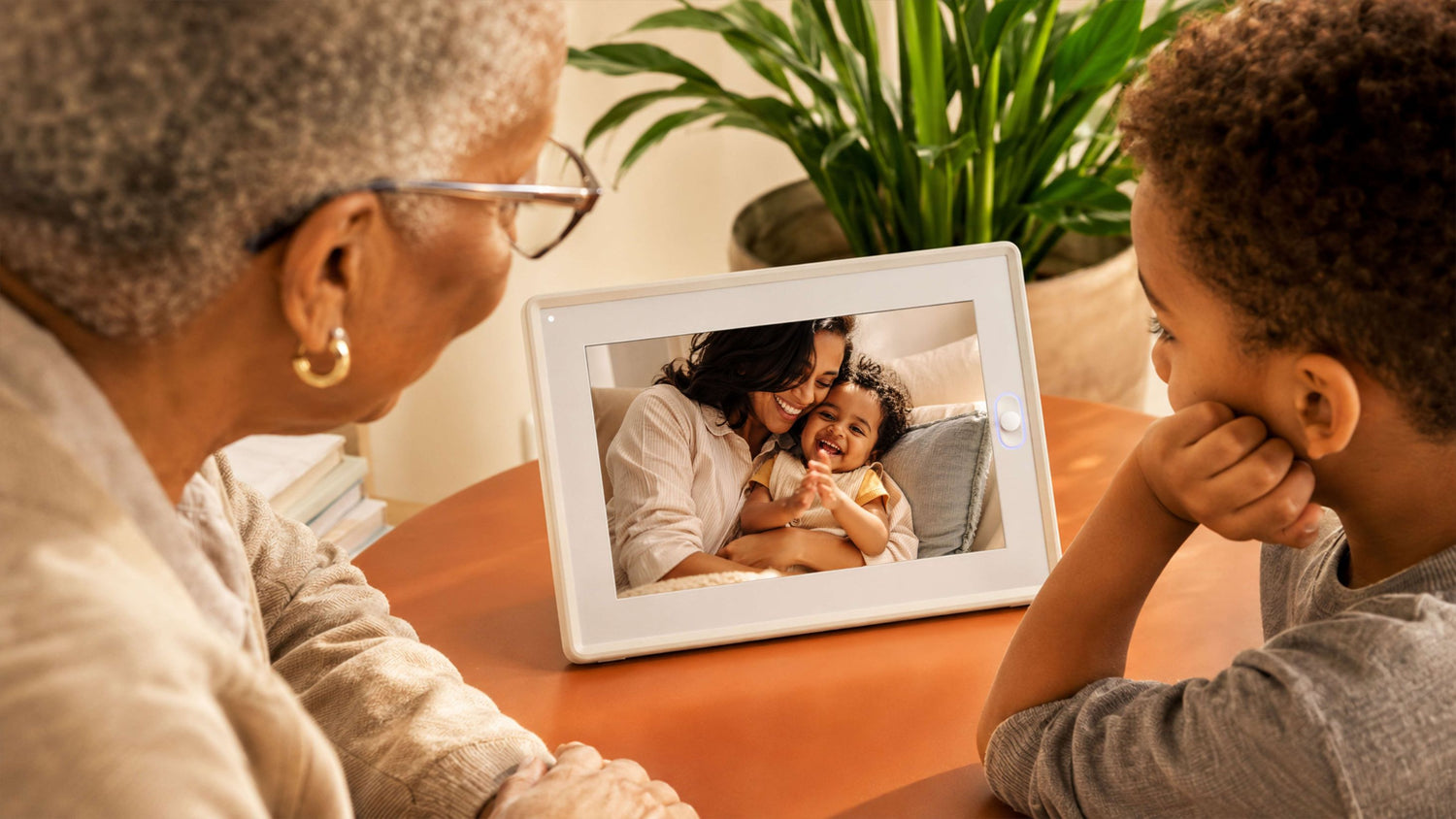 The AmivoFrame conversational AI smart photo frame displaying a happy family portrait on a wooden table