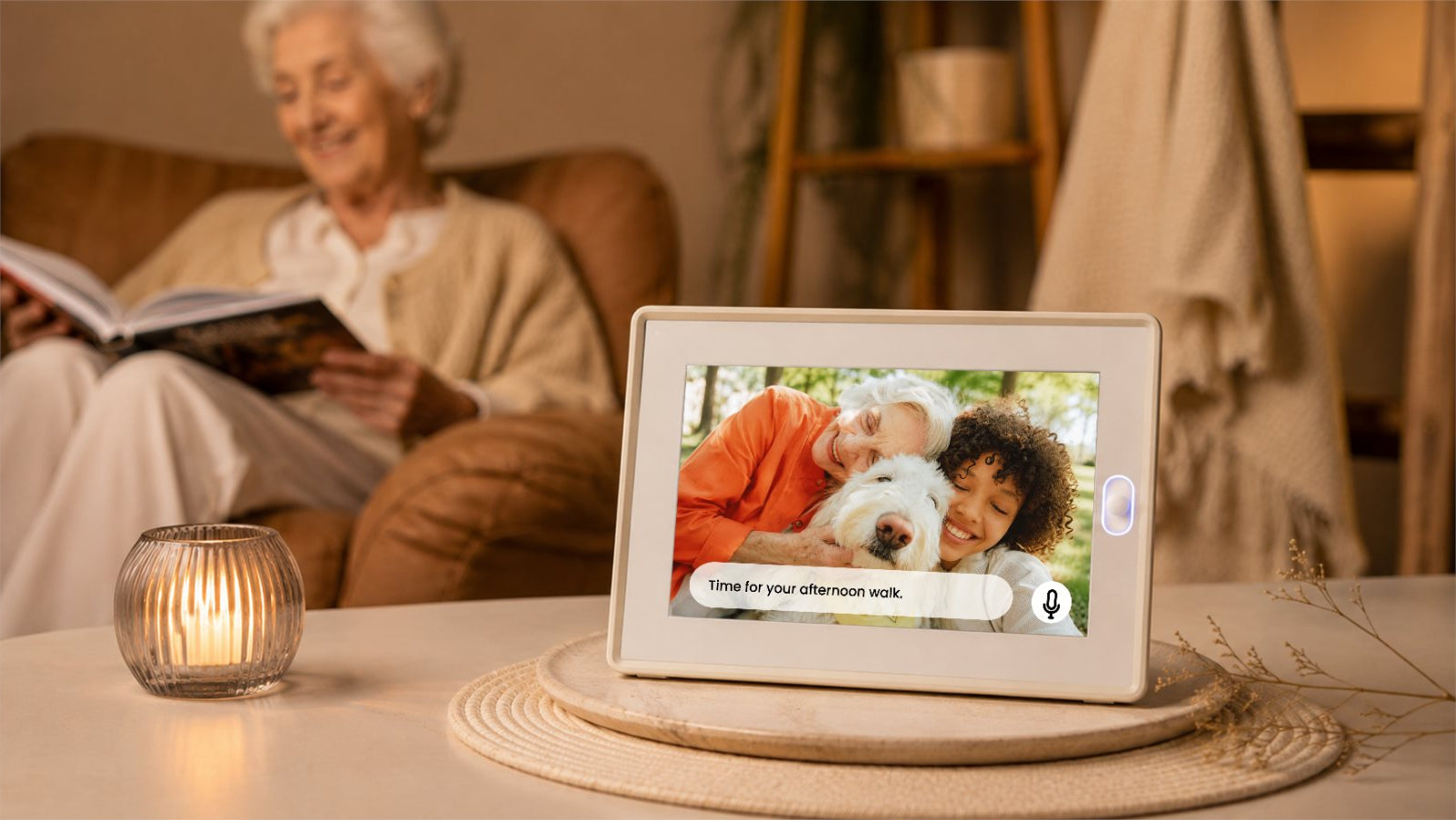 The AmivoFrame conversational AI smart photo frame displaying a happy family portrait on a wooden table in a beautifully styled, sunlit modern living room with a green sofa.